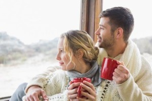 couple looking out with cups