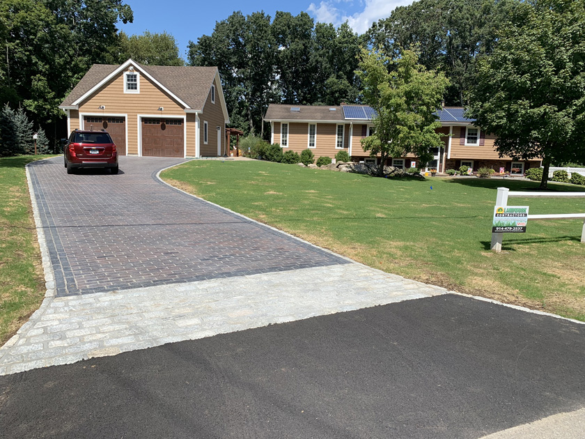 The finished product paver driveway, belgium block border, blacktop, and grass.JPEGThe finished product paver driveway, belgium block border, blacktop, a